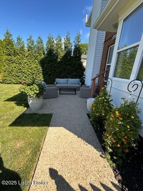 view of yard with an outdoor living space and a patio