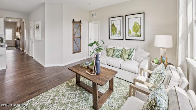 living room with dark hardwood / wood-style flooring