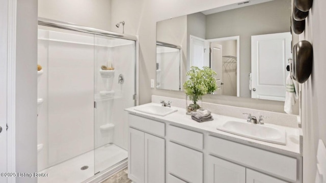 bathroom featuring vanity and an enclosed shower