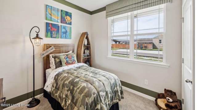 carpeted bedroom featuring multiple windows