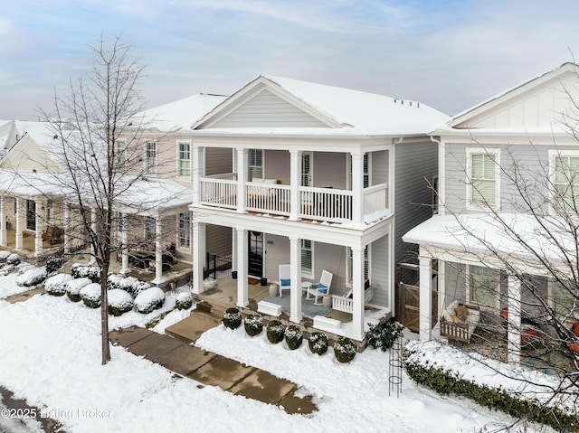 view of front facade with a balcony and covered porch