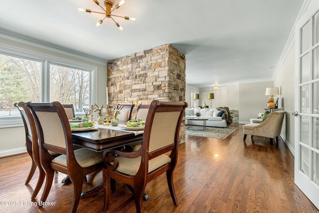 dining space featuring hardwood / wood-style floors, ornamental molding, and a chandelier