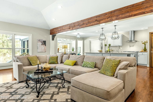 living room with sink, hardwood / wood-style floors, and lofted ceiling