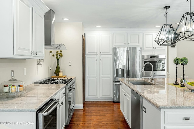 kitchen featuring white cabinets, wine cooler, appliances with stainless steel finishes, and pendant lighting