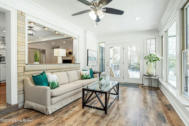 sunroom with ceiling fan and lofted ceiling