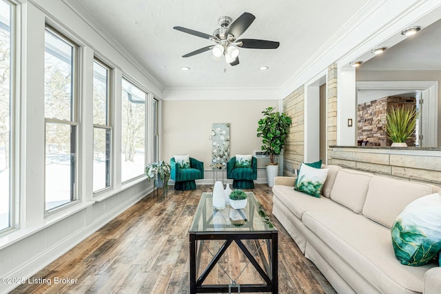 sunroom featuring ceiling fan