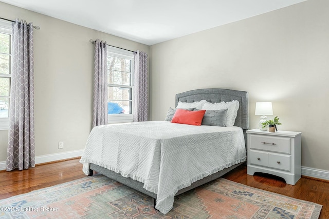 bedroom with dark hardwood / wood-style floors