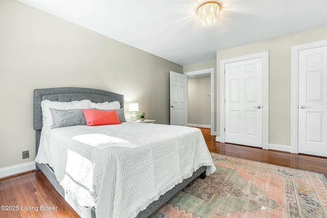 bedroom with dark hardwood / wood-style floors