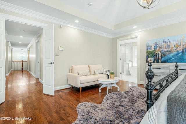 bedroom featuring crown molding, dark hardwood / wood-style floors, an inviting chandelier, and ensuite bath