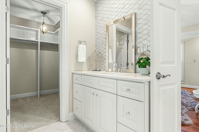 bathroom featuring vanity and ornamental molding