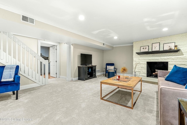 living room featuring a stone fireplace, carpet, and ornamental molding