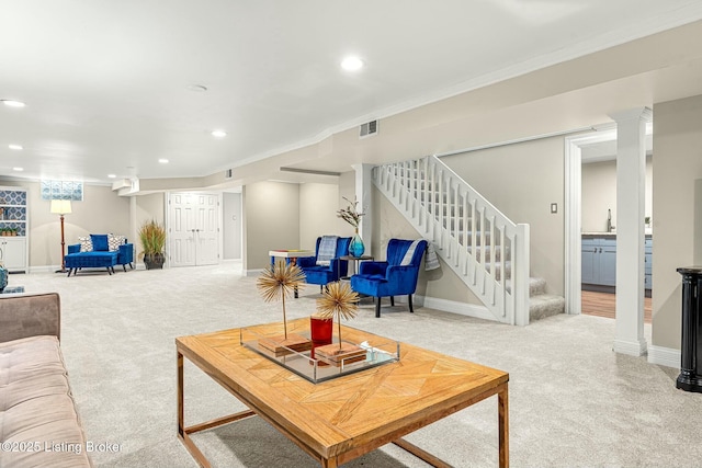 living room featuring decorative columns, carpet, and ornamental molding