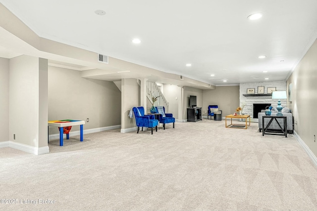 game room featuring light colored carpet, crown molding, and a fireplace