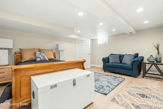 bedroom with light hardwood / wood-style flooring and fridge