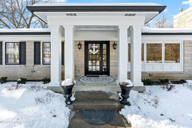 view of snow covered property entrance