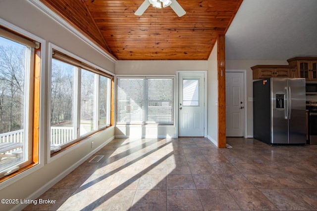 unfurnished sunroom featuring vaulted ceiling, ceiling fan, and wood ceiling