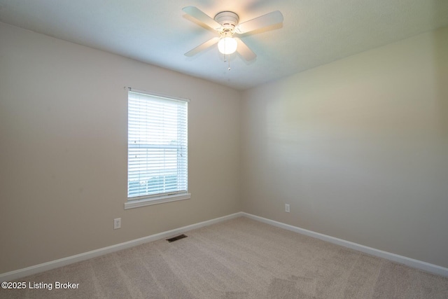 spare room featuring carpet floors and ceiling fan