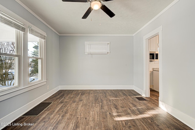 empty room with ceiling fan, dark wood-type flooring, and ornamental molding