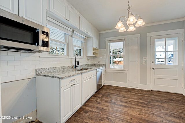 kitchen featuring sink, a wealth of natural light, white cabinets, and stainless steel appliances