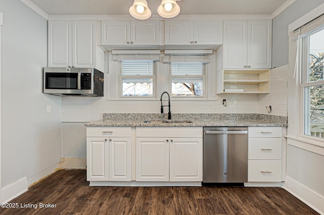 kitchen featuring stainless steel appliances, tasteful backsplash, ornamental molding, white cabinets, and sink