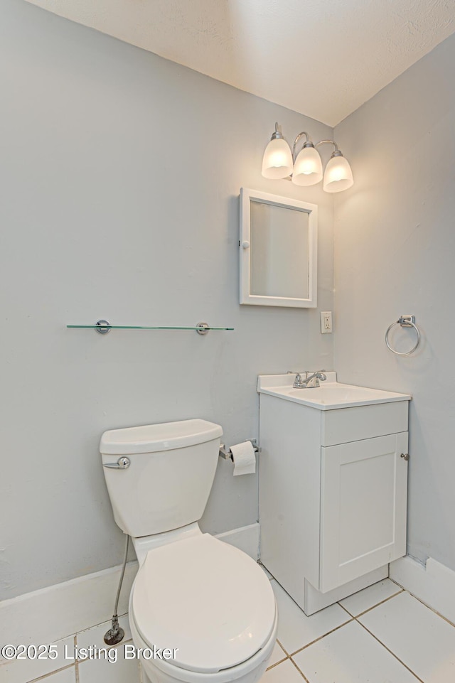 bathroom featuring tile patterned floors, vanity, and toilet