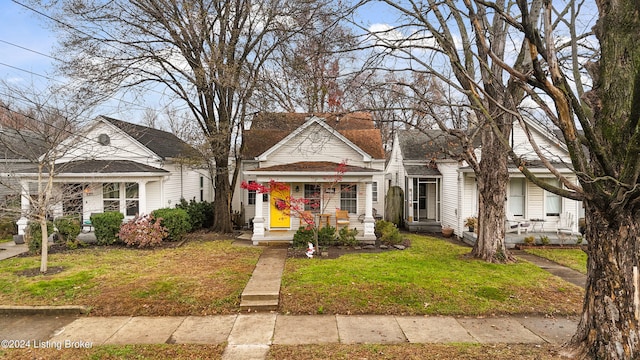 bungalow-style house featuring a front lawn