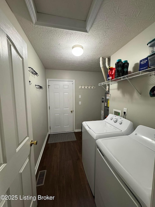 washroom featuring washer and clothes dryer, dark hardwood / wood-style floors, and a textured ceiling