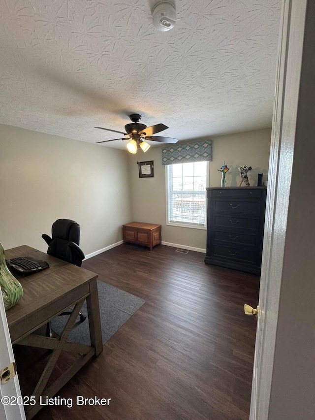 office with a textured ceiling, ceiling fan, and dark hardwood / wood-style floors