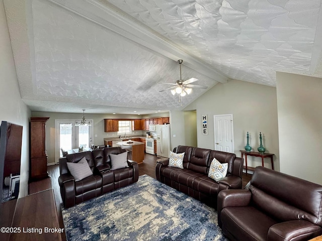 living room featuring ceiling fan with notable chandelier, a textured ceiling, lofted ceiling with beams, and dark wood-type flooring