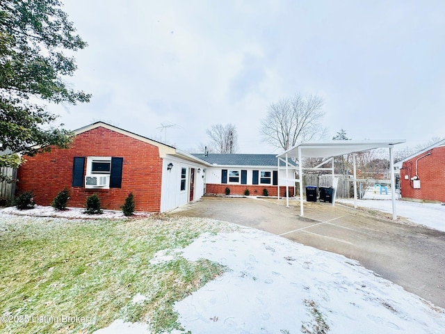 view of front of property featuring cooling unit and a carport