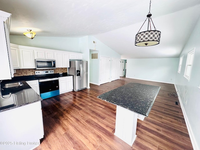 kitchen with decorative light fixtures, white cabinets, backsplash, and stainless steel appliances