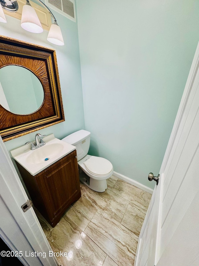 bathroom with toilet and vanity