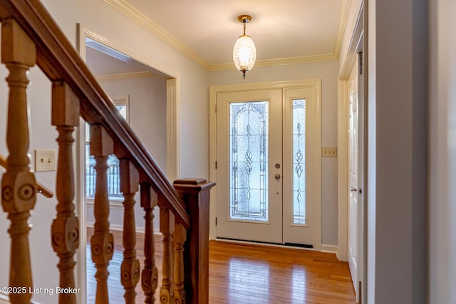 entrance foyer featuring light hardwood / wood-style floors and ornamental molding