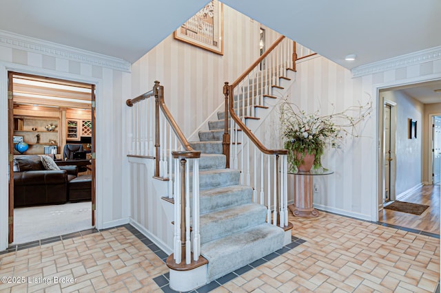 staircase featuring crown molding