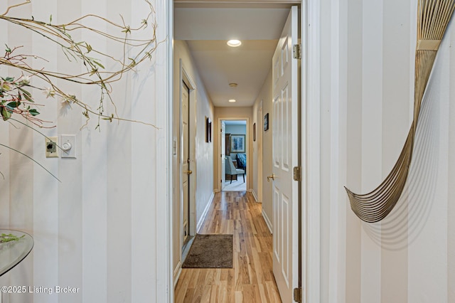 corridor with light hardwood / wood-style floors