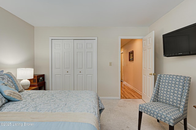 bedroom featuring a closet and light colored carpet