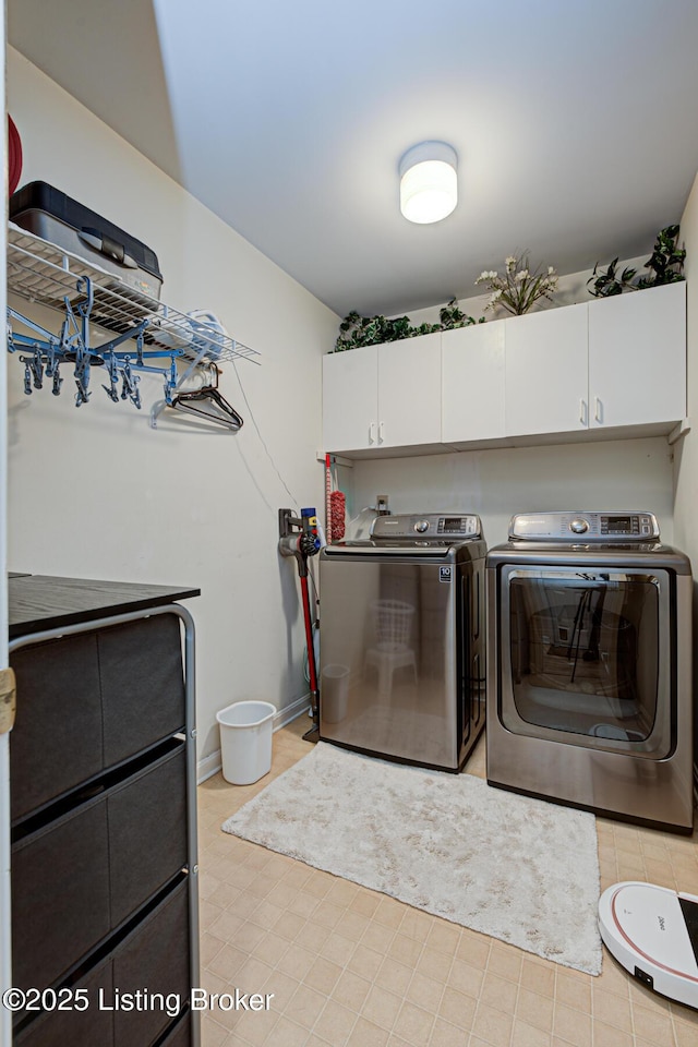 laundry room with cabinets and washing machine and dryer