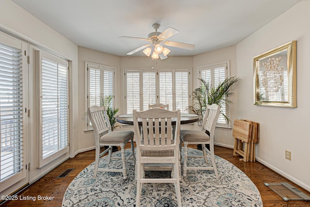 dining space featuring ceiling fan and dark wood-type flooring