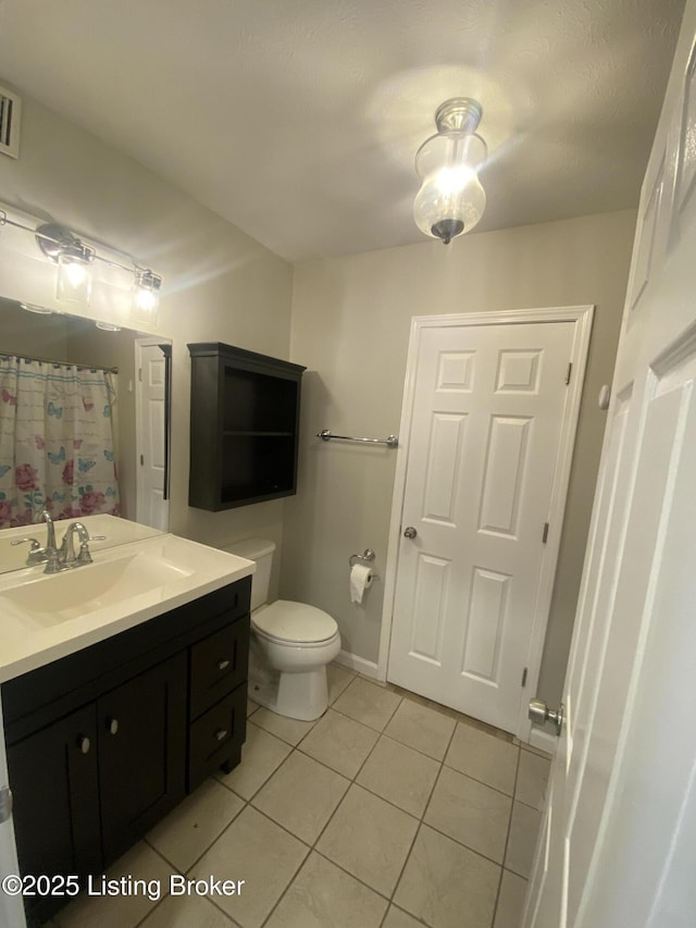 bathroom with tile patterned flooring, vanity, toilet, and a shower with curtain