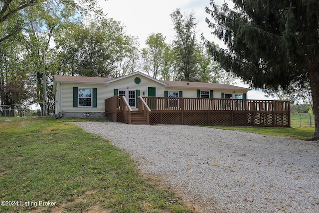 view of front of home featuring a deck and a front lawn