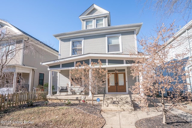 view of front facade featuring french doors and covered porch