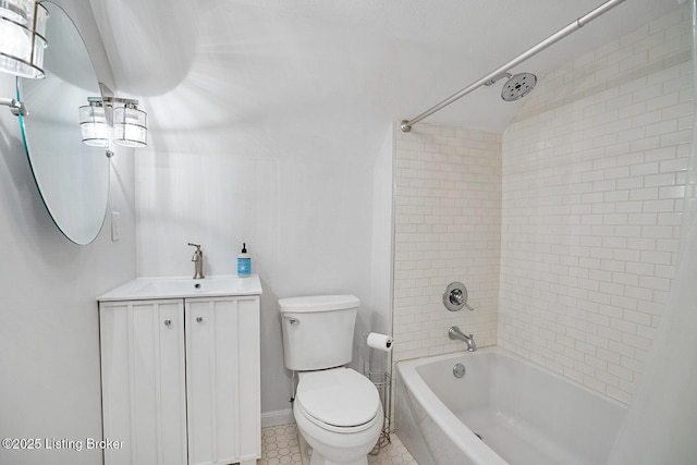 full bathroom featuring tiled shower / bath, vanity, and toilet