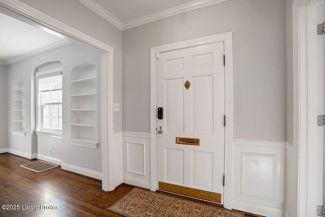 foyer entrance featuring crown molding and dark hardwood / wood-style floors