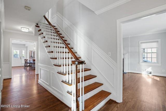 staircase with crown molding and hardwood / wood-style flooring