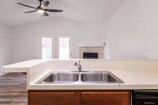 kitchen featuring dishwasher, sink, vaulted ceiling, ceiling fan, and dark hardwood / wood-style flooring