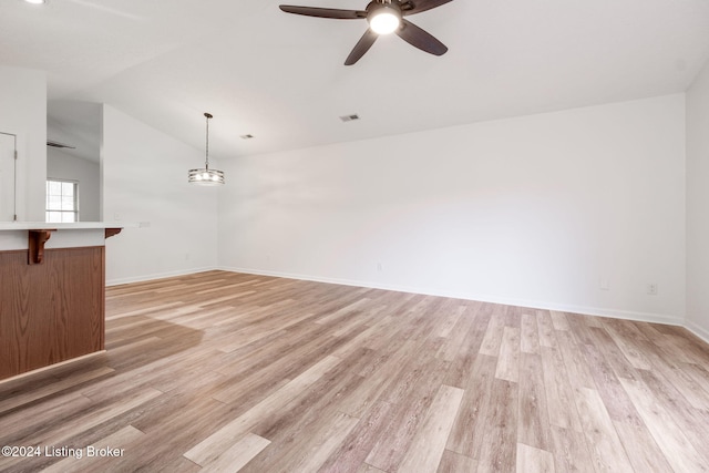 unfurnished living room featuring light wood-type flooring, ceiling fan, and lofted ceiling