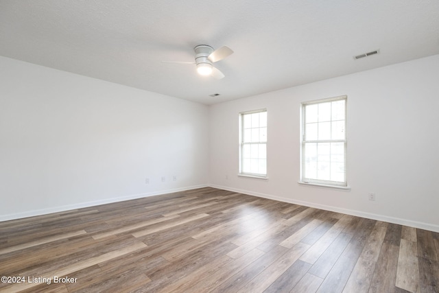 spare room with ceiling fan and wood-type flooring