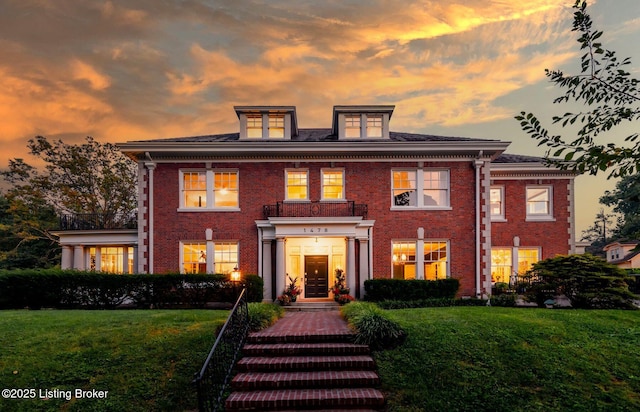 back house at dusk with a yard