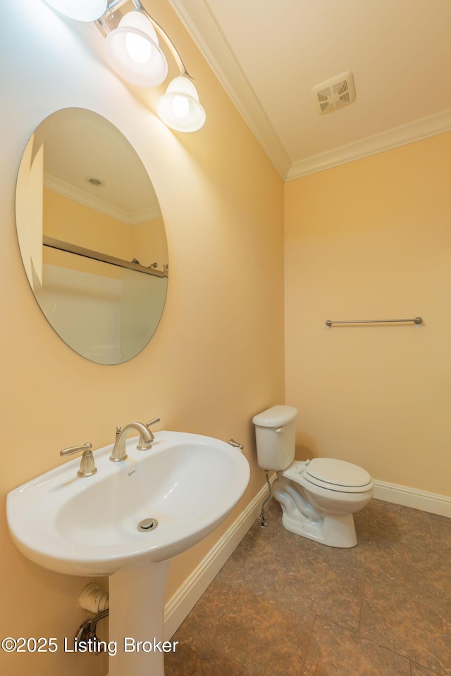 bathroom featuring crown molding, toilet, and sink