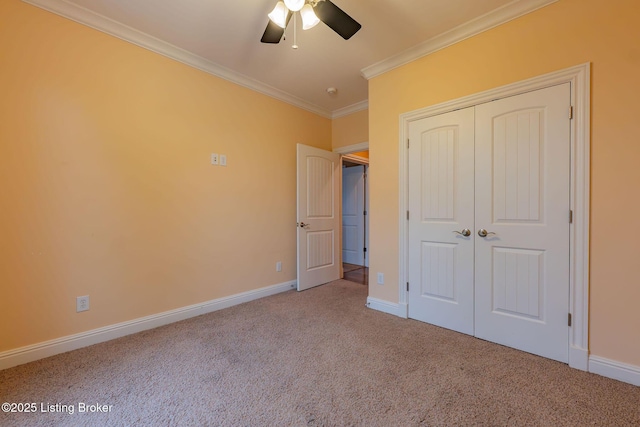 unfurnished bedroom with ornamental molding, light carpet, ceiling fan, and a closet